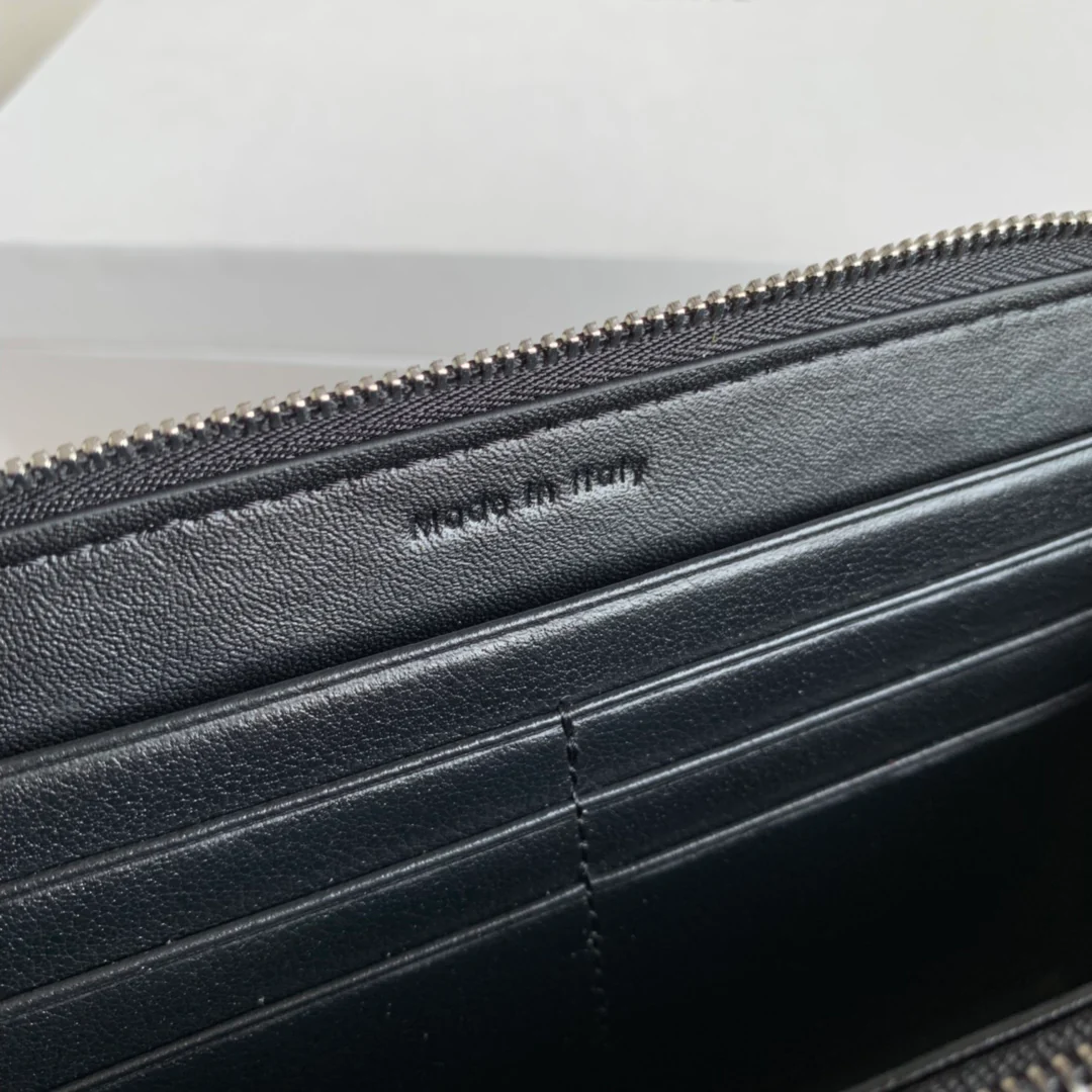 Длинный кошелек Celine на молнии — черный с узором в виде ряби на воде.