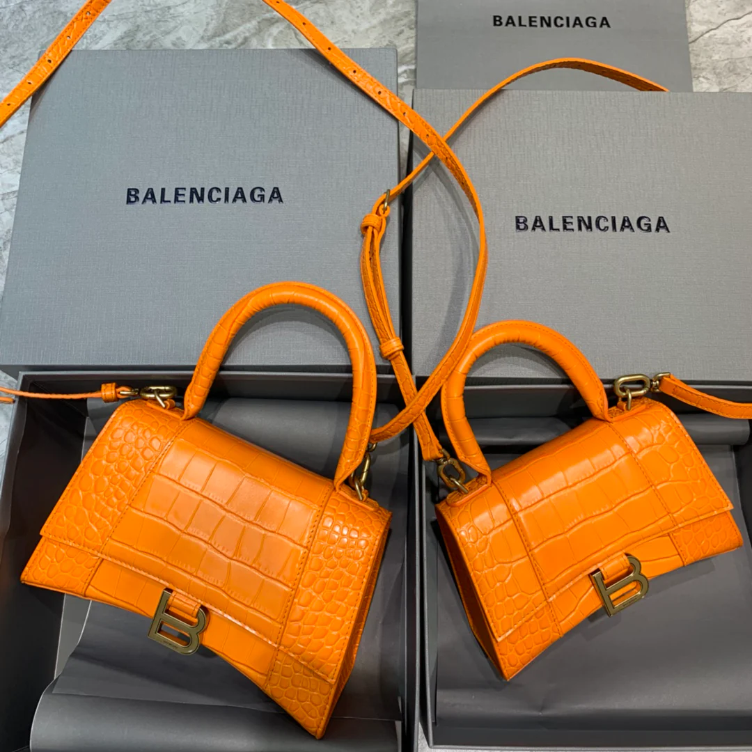 Сумка Balenciaga Hourglass — оранжевая с тиснением под крокодиловую кожу и золотой пряжкой.