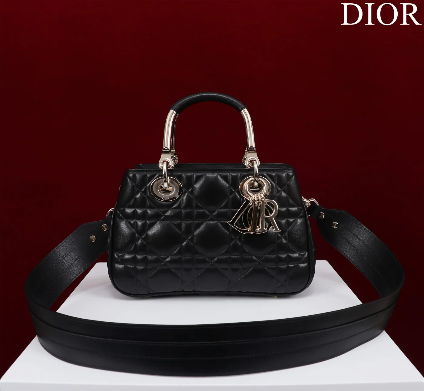 Сумка Dior Lady 95 22, средний размер, черная с золотой пряжкой.