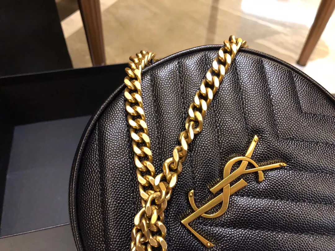 Маленькая круглая сумка YSL Vinyle - черная с золотой фурнитурой.