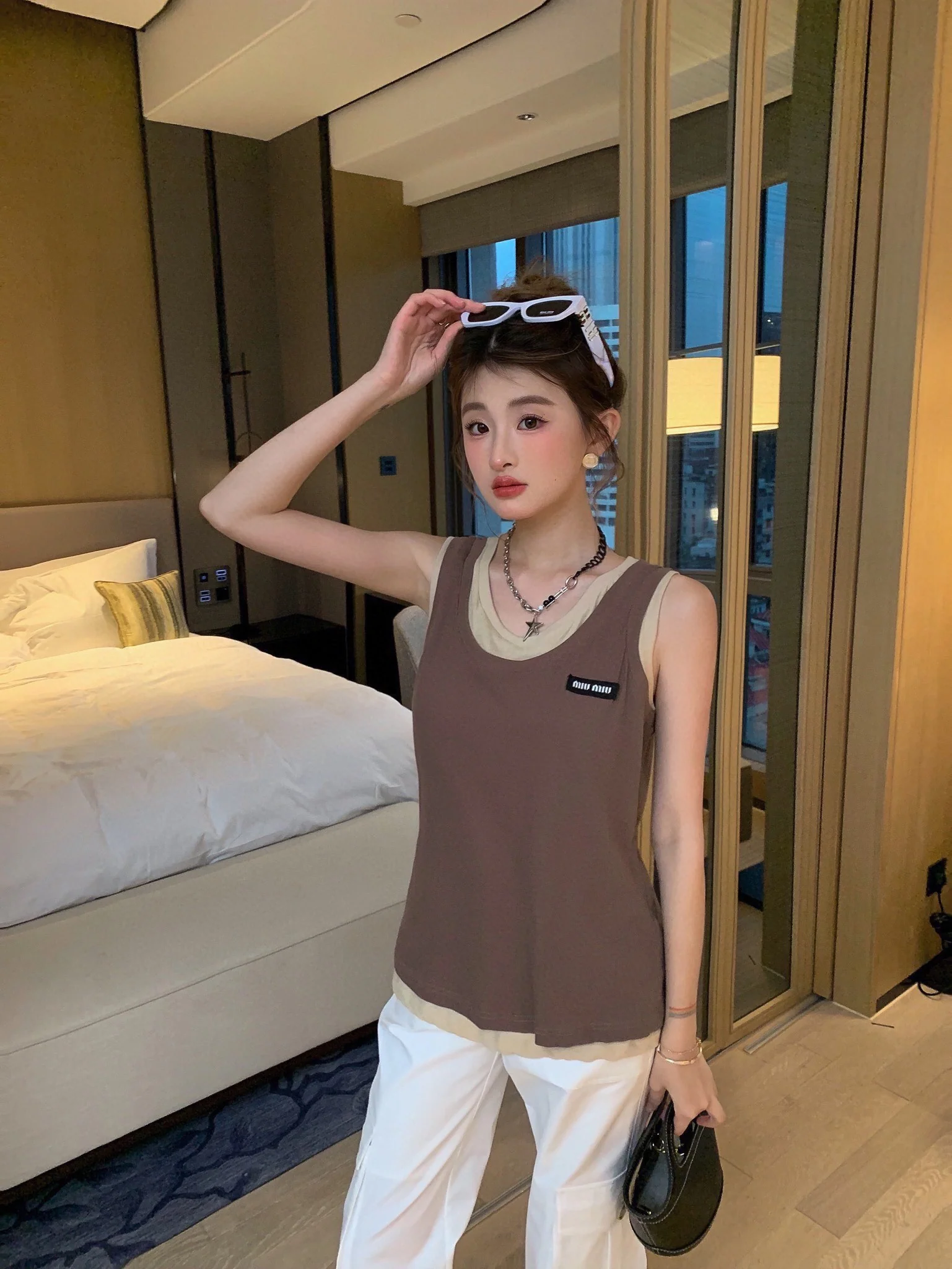 Новинка сезона весна/лето 2024 от Miu Miu: многослойный, культовый универсальный жилет — коричневый.