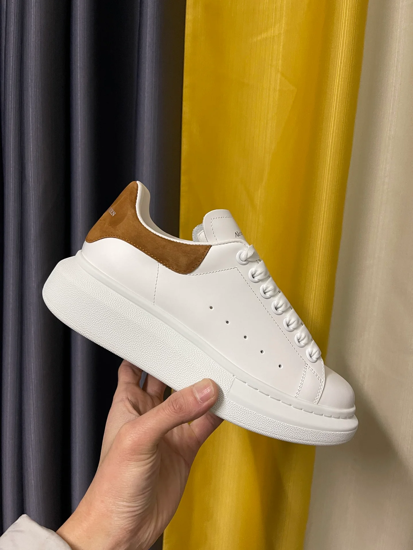 Классические белые кроссовки McQueen с коричневой замшевой подошвой на каблуке.