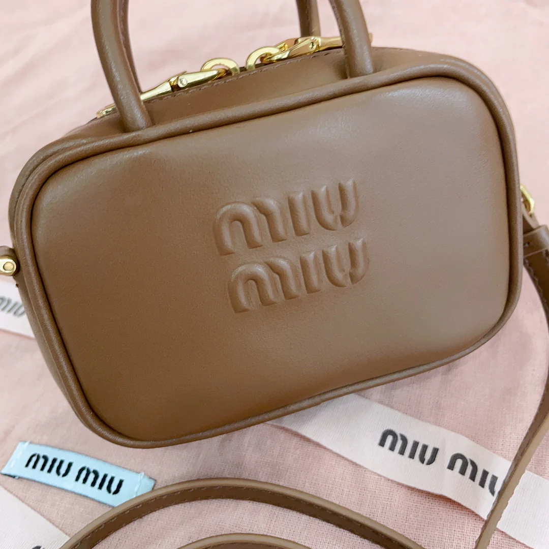 Мини-портфель Miu Miu с брелоком — из телячьей кожи.