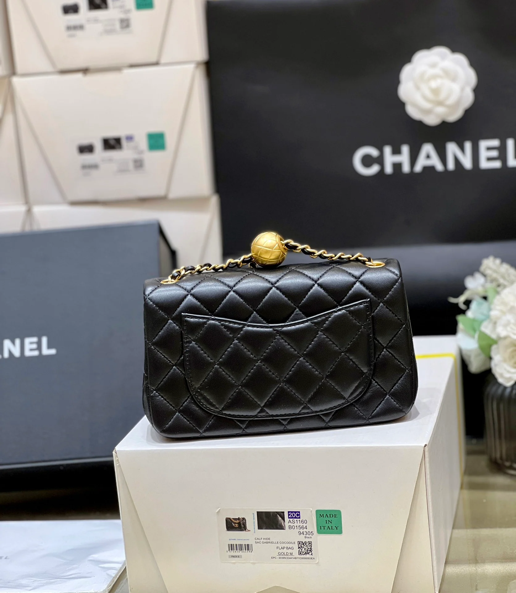 Мини-сумочка Chanel с клапаном, золотым логотипом и маленьким золотым шариком - черная.