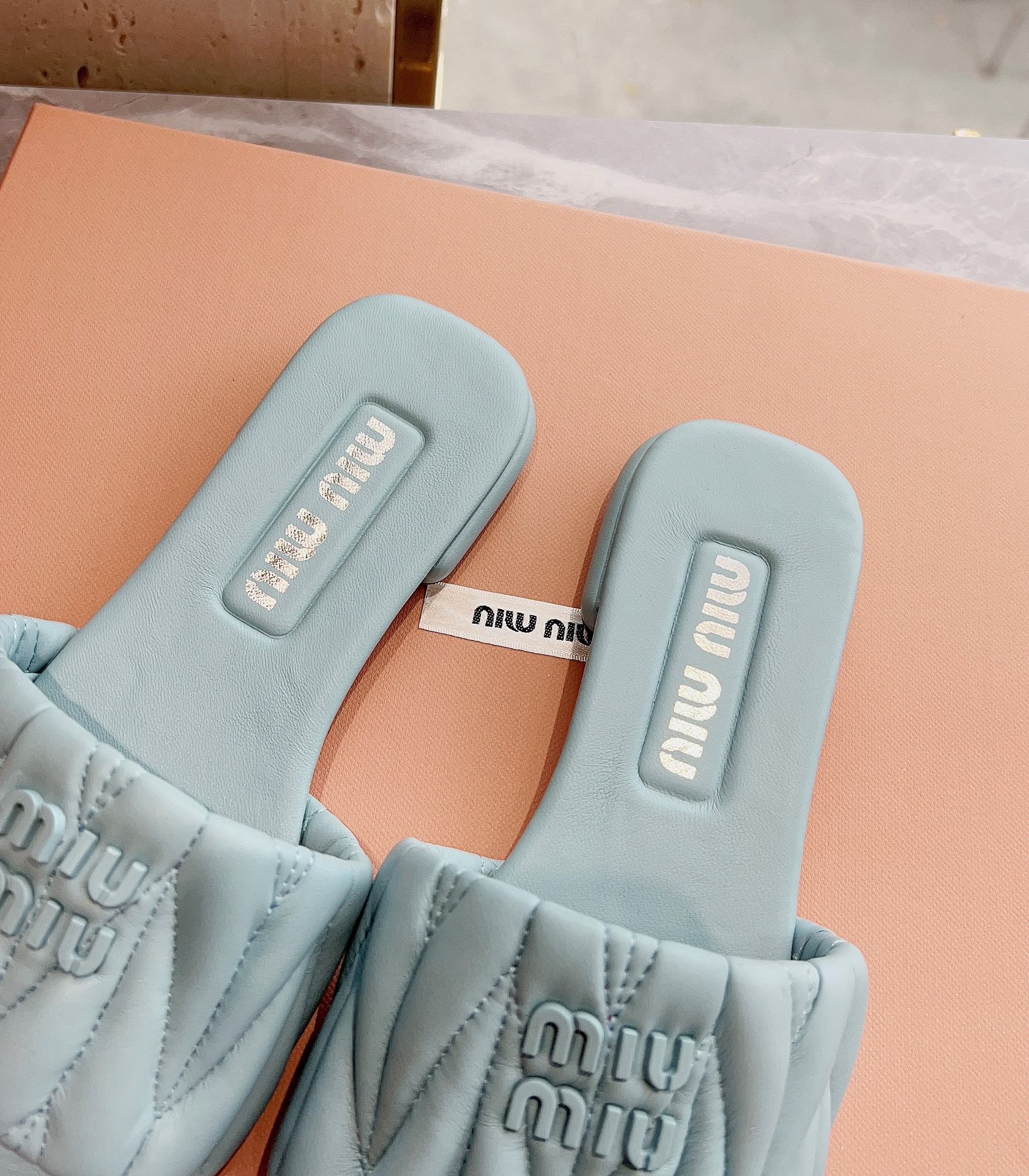 Новинка сезона весна/лето 2023 от Miu Miu - плоские тапочки из овечьей кожи - светло-серые.