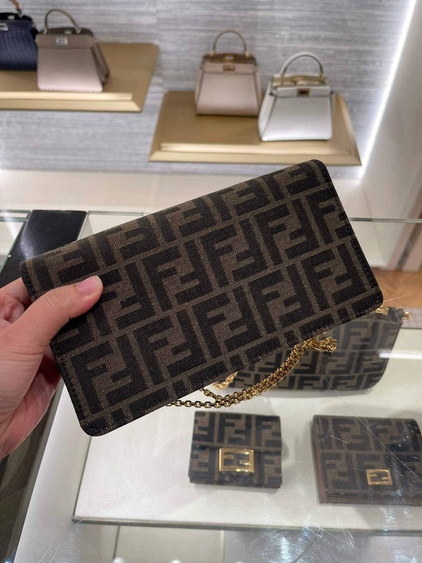 Сумка Fendi с монограммой и цепочкой под мышкой