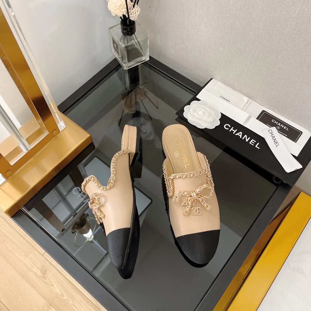 Кожаные мюли Chanel с цепочкой и бантом.