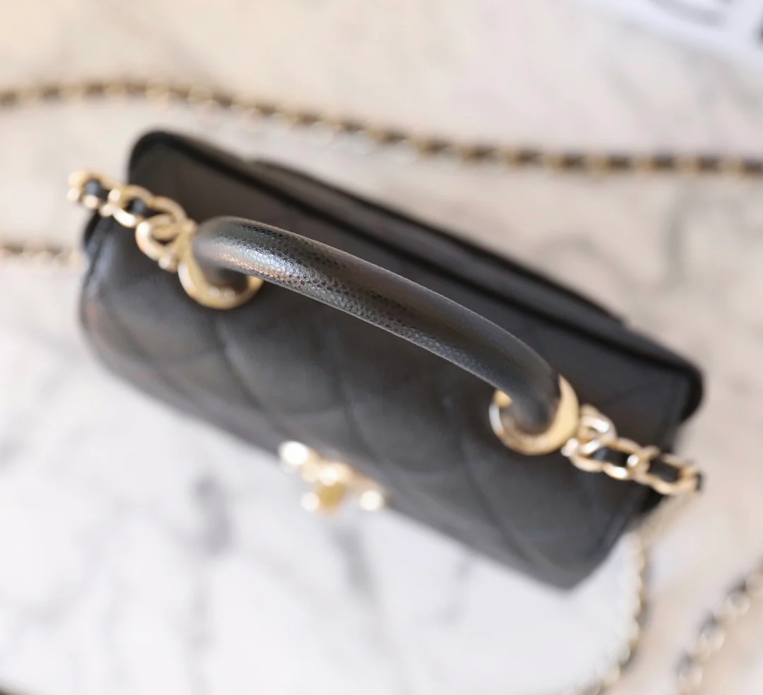 Сумка Chanel с цепочкой и клапаном — черная с фурнитурой из светлого золота.