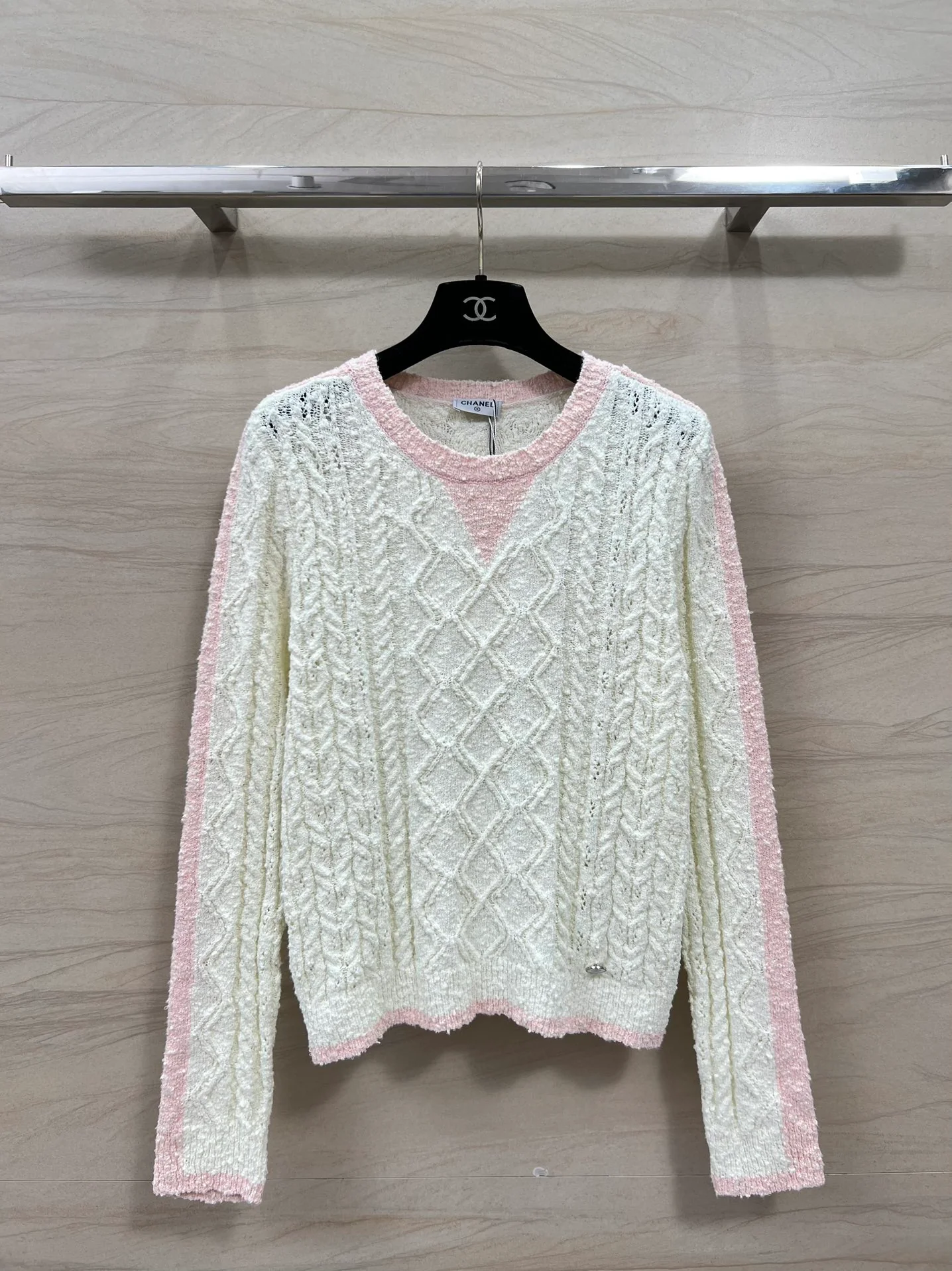 Вязаный топ с длинными рукавами из коллекции Chanel 2403 Resort, розово-белый.