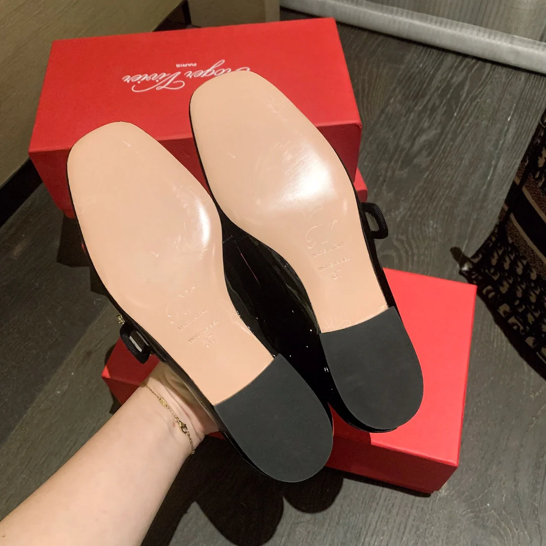 Лакированные балетки с пряжками, украшенными стразами — черные.