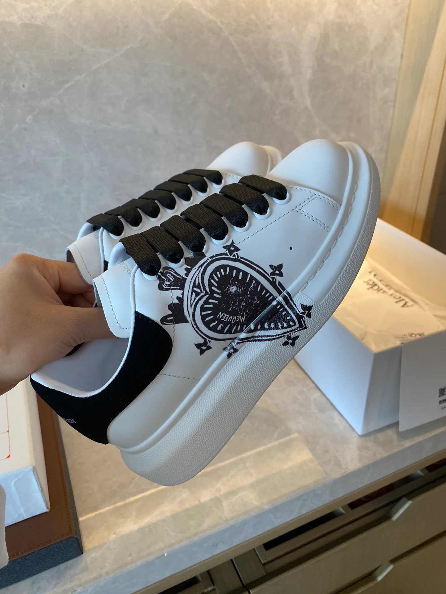 Классические белые кроссовки McQueen с рисунком в виде сердечек на верхней части.