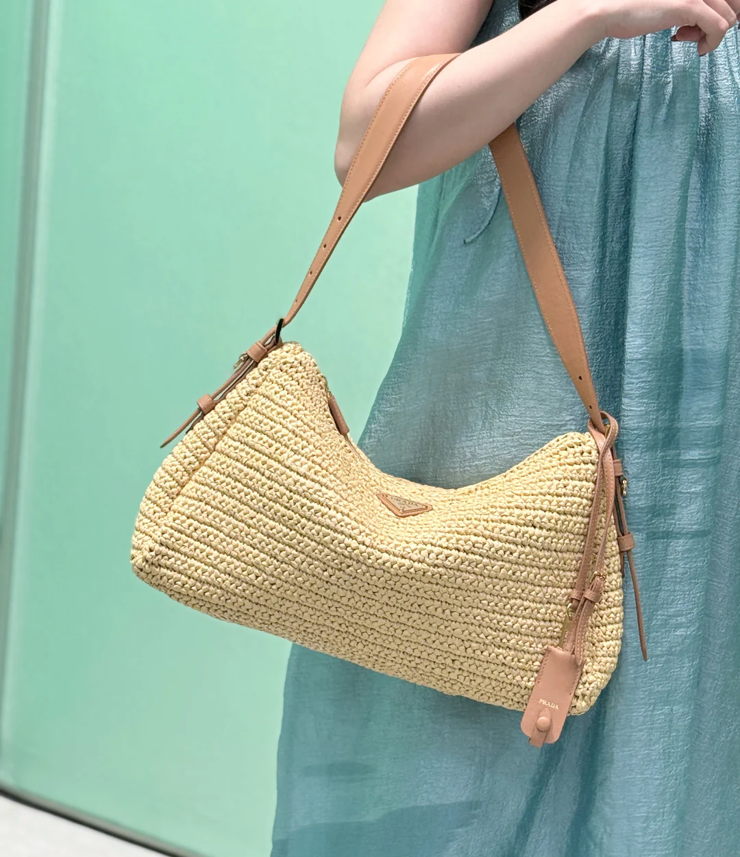 Сумка Prada Aimee из соломы, которую можно носить под мышкой.