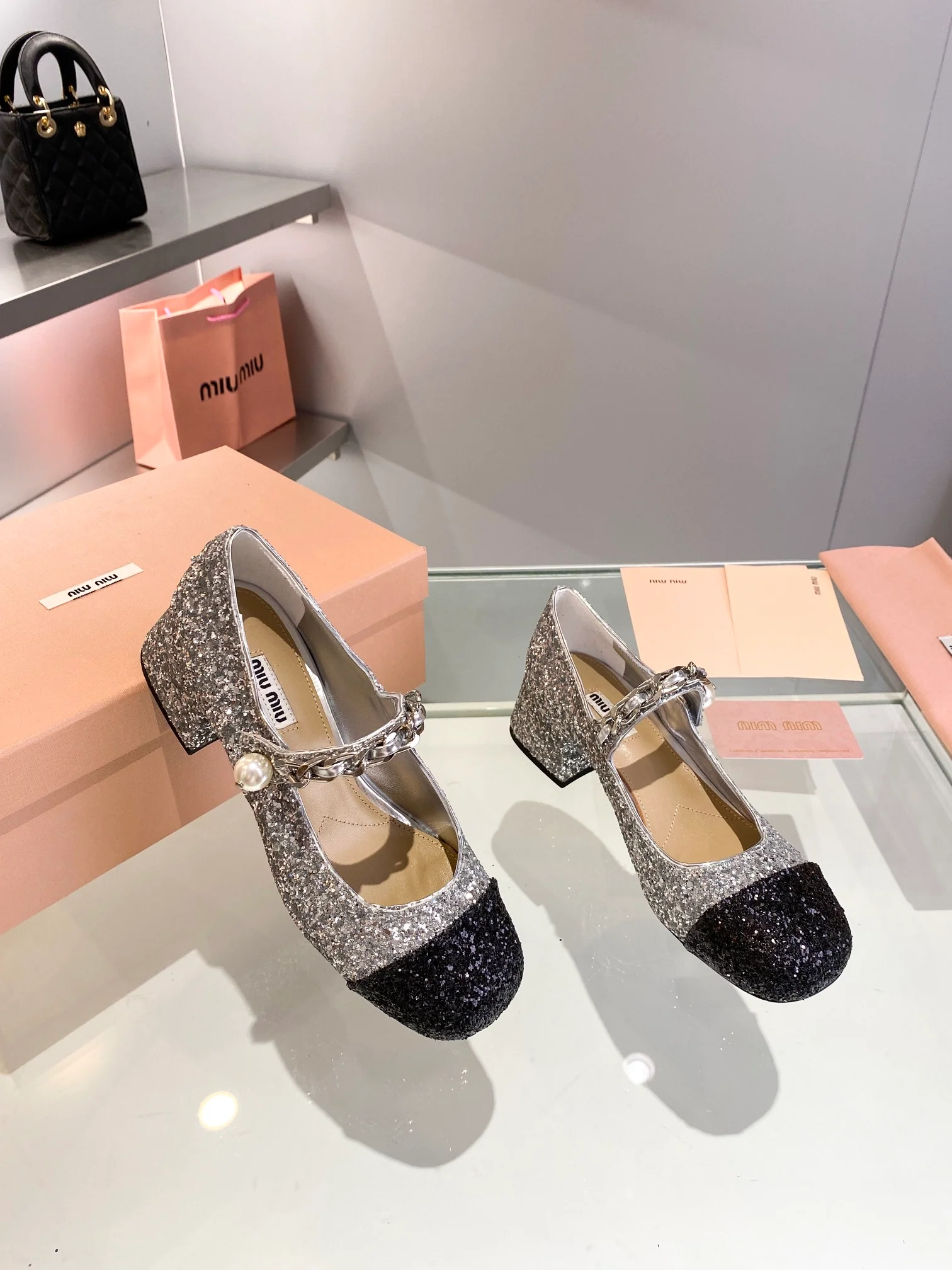 Новинка осенне-зимней коллекции Miu Miu 2023 — балетки со стразами — на низком каблуке — серебристые.