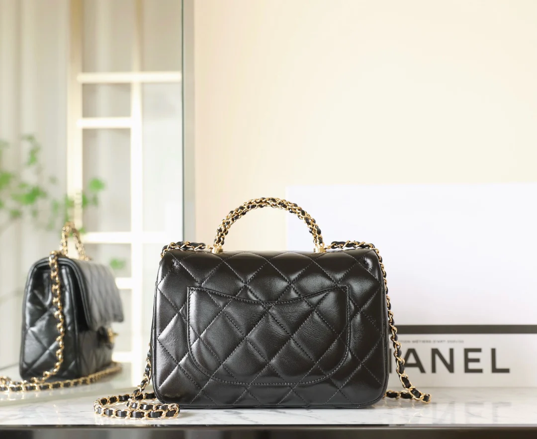 Большая черная сумка Chanel с клапаном и поворотной ручкой.