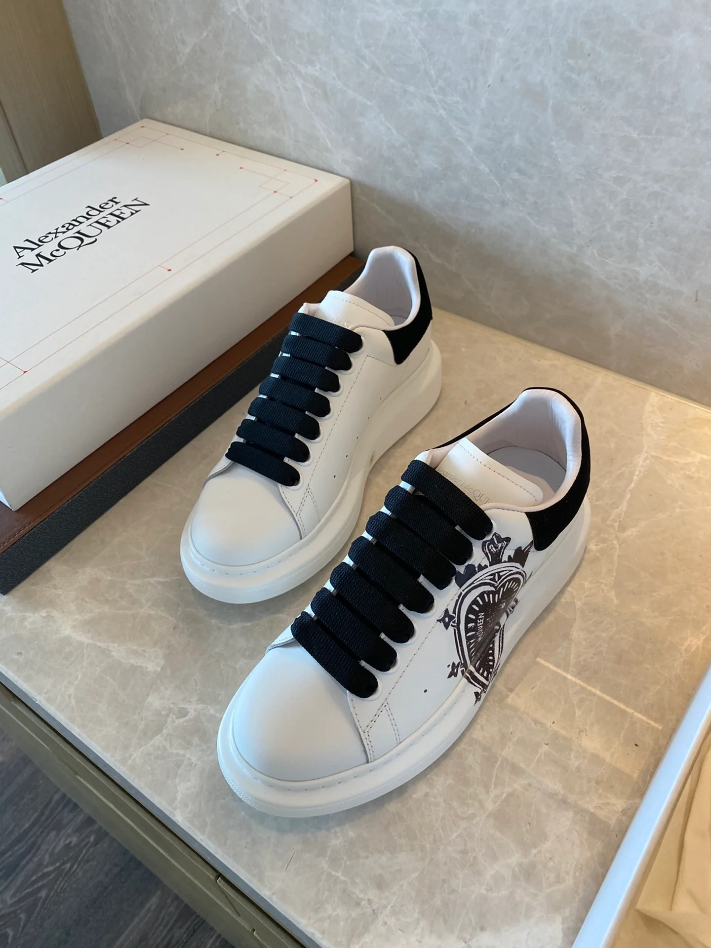 Классические белые кроссовки McQueen с рисунком в виде сердечек на верхней части.