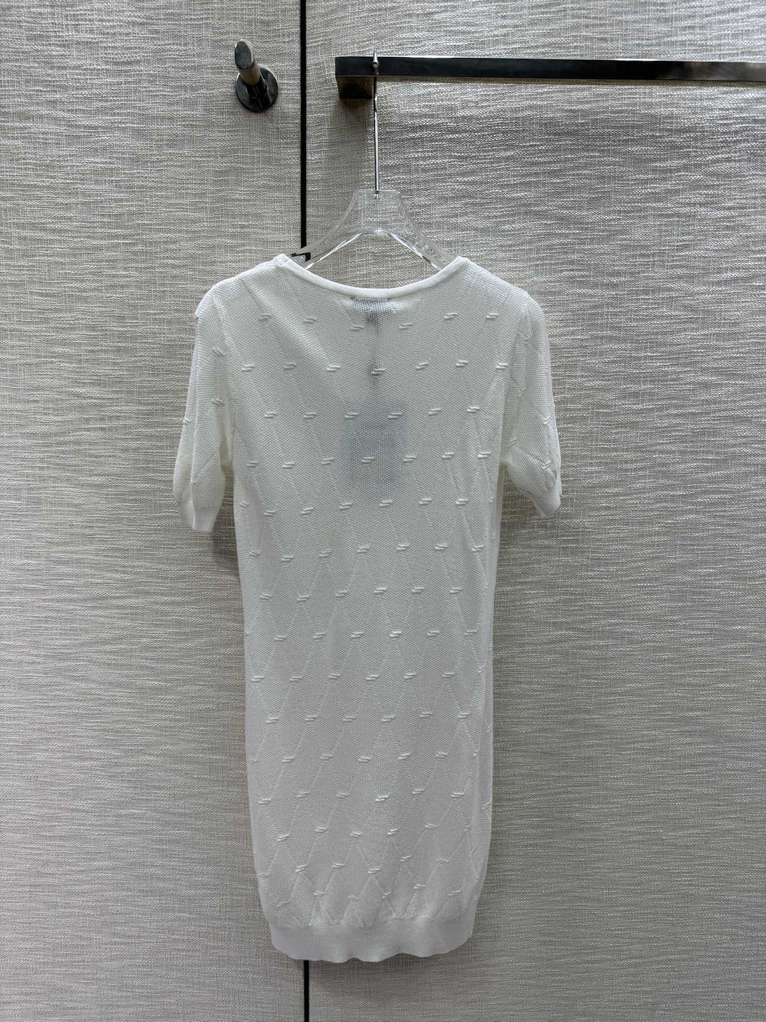 Новая коллекция Chanel Весна/Лето 2024: трикотажное платье с короткими рукавами и ромбовидным узором, белое.