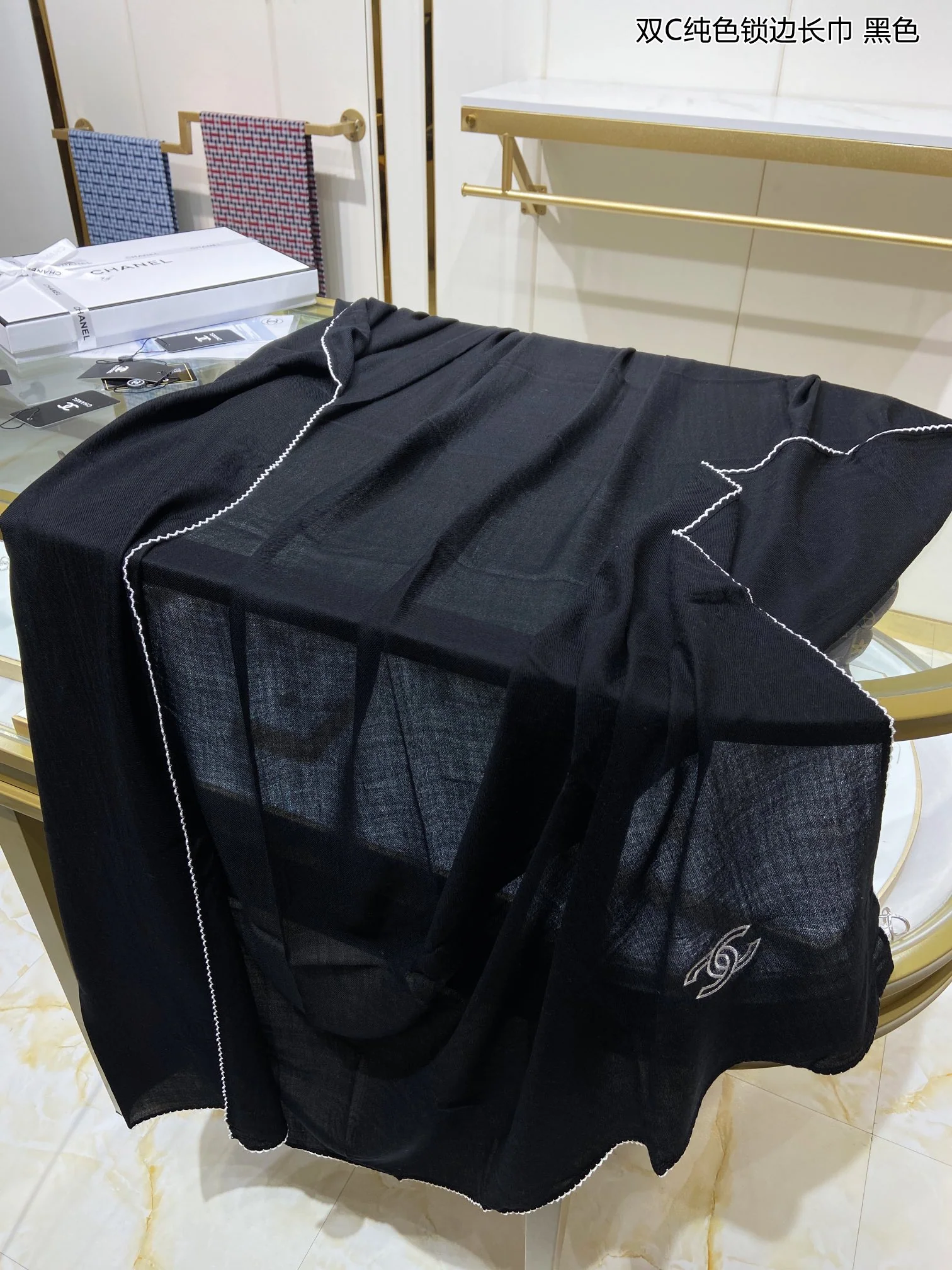 Однотонный кашемировый шарф Chanel с оверлочной отделкой.