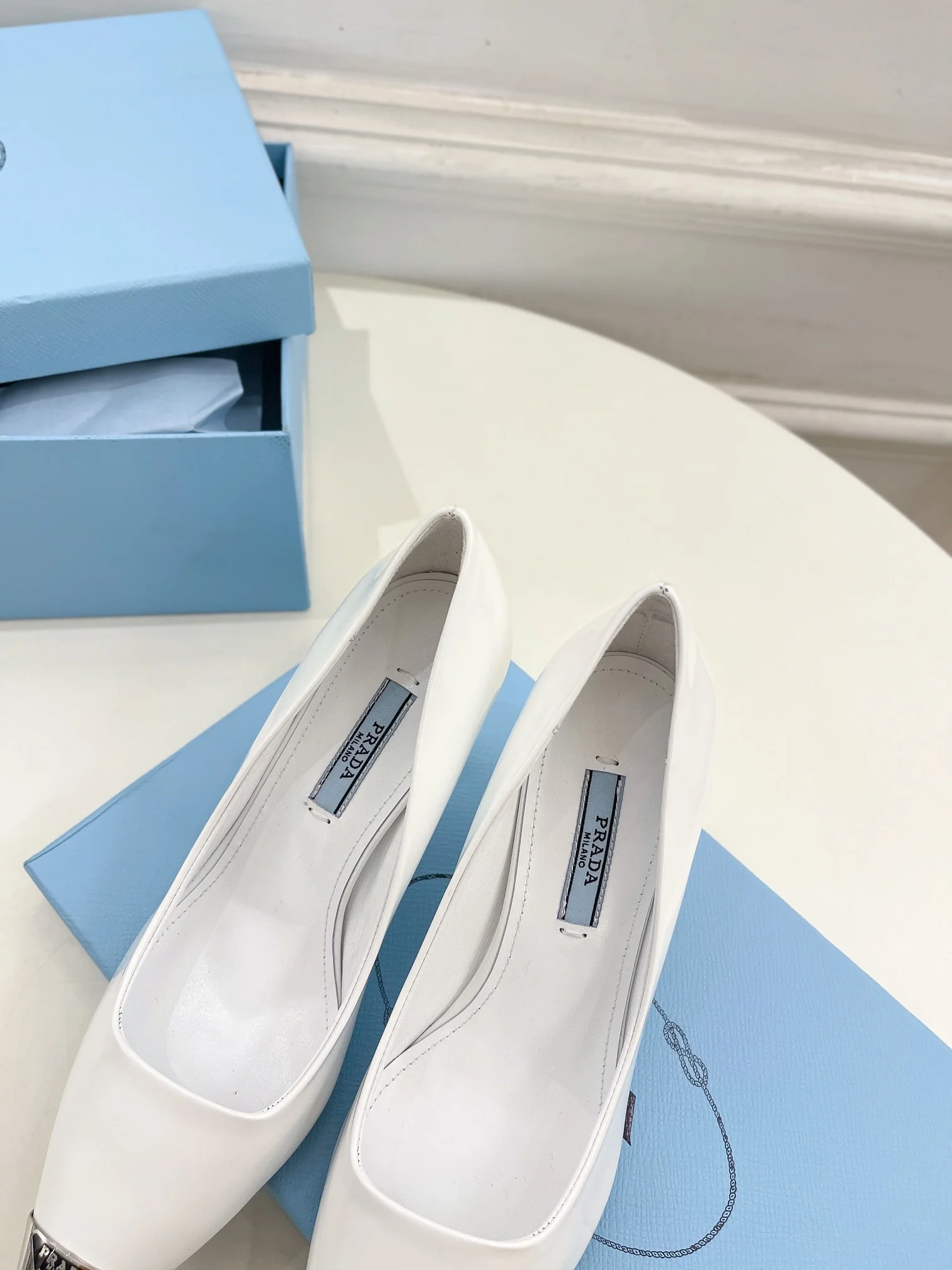Новинка весны 2023 года от Prada - туфли на высоком каблуке с острым носком - белые.