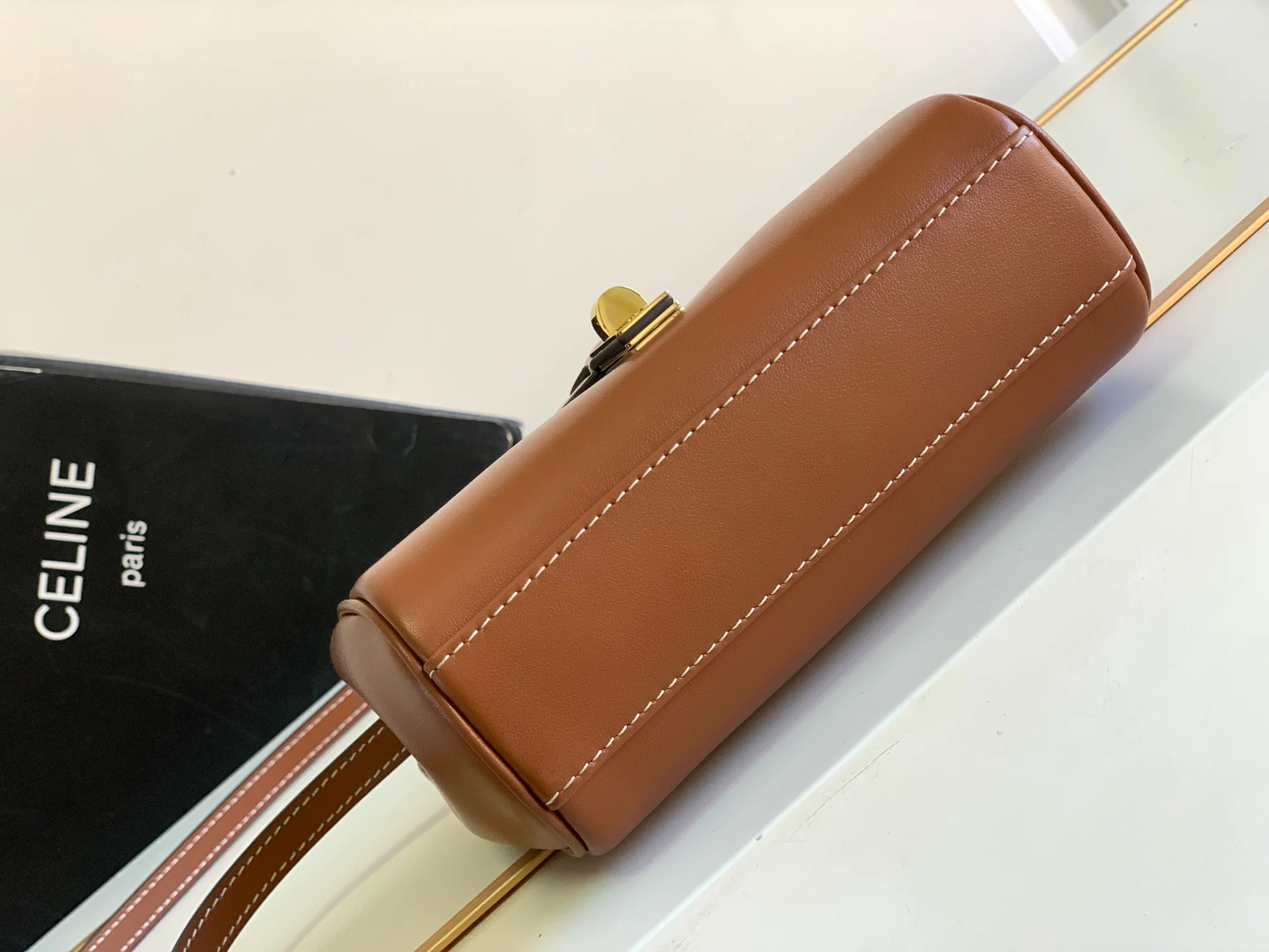 Новинка весны 2023 года от Celine - Миниатюрная сумка из мягкой зернистой телячьей кожи (16%) - Коричневая.