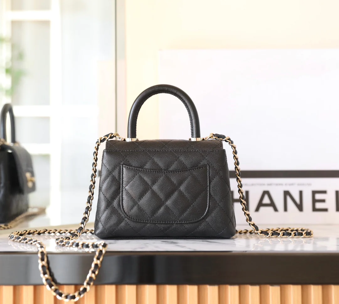 Сумка Chanel с цепочкой и клапаном — черная с фурнитурой из светлого золота.