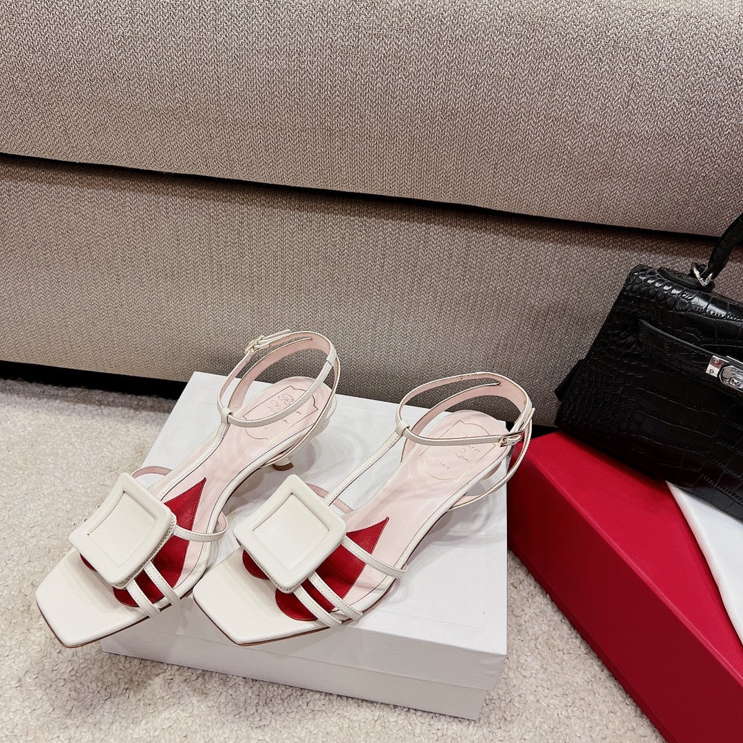 Сандалии RV Shoes - белые, с квадратной пряжкой, на низком каблуке и ремешками.