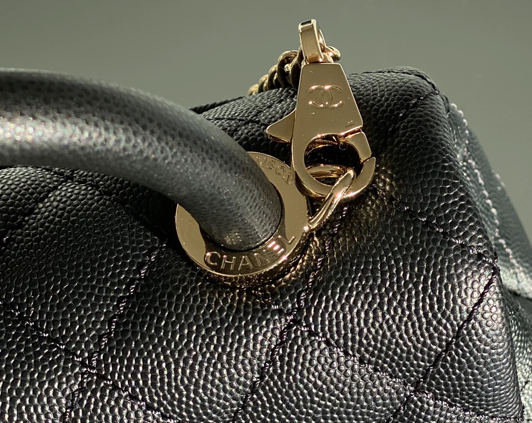 Мини-сумка Chanel Coco Handle — черная кожа с золотистой пряжкой.