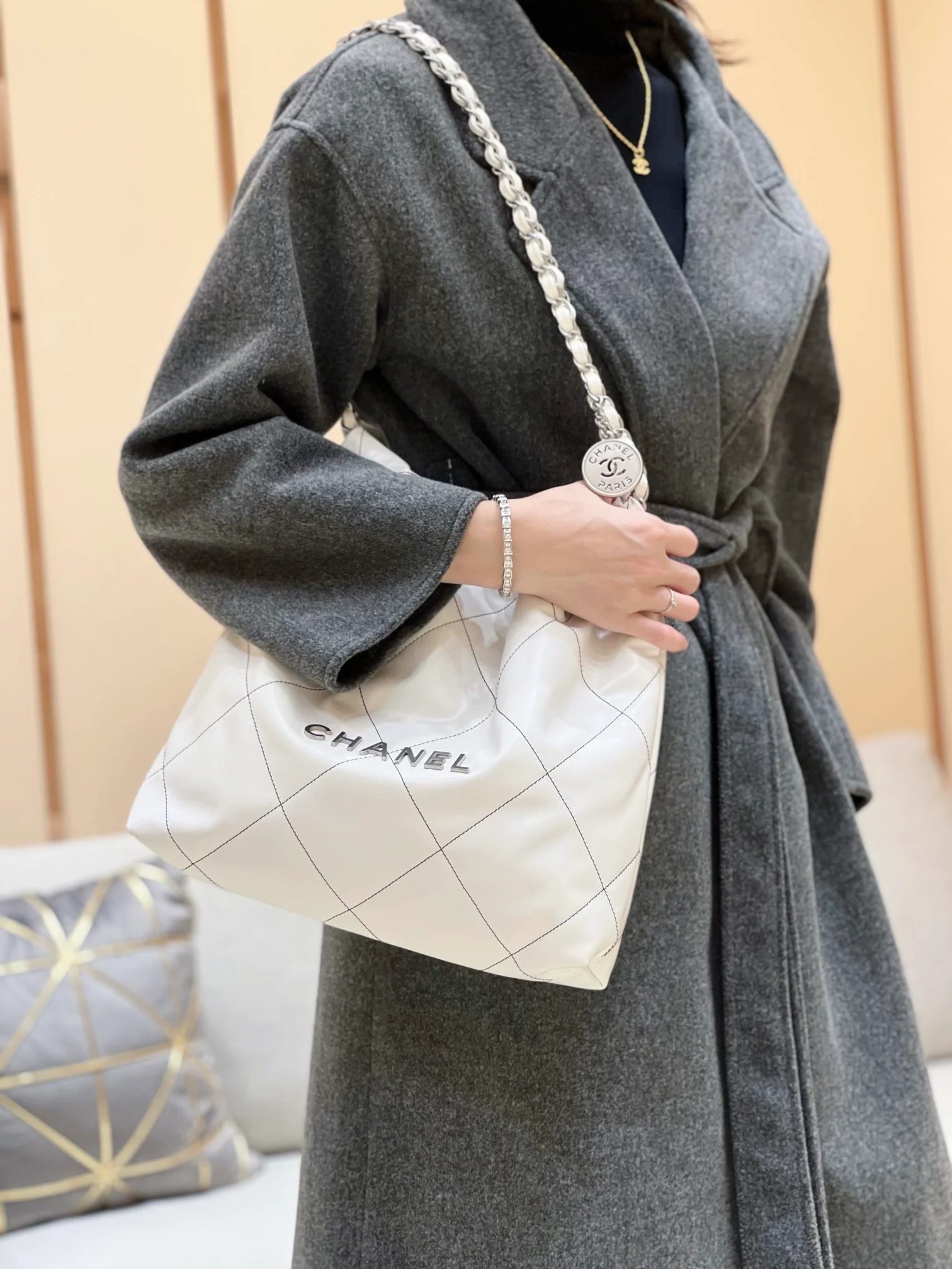 Сумка Chanel из круизной коллекции 2023 года - 22bag - Маленькая - Белая с черной строчкой - На фото сумка в носке.