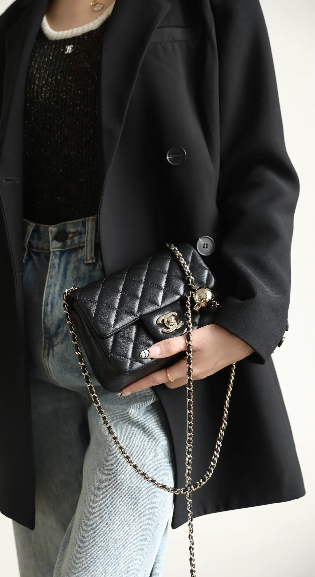 Сумка-шар Chanel из 25-каратного золота с регулируемой застежкой, черная с фурнитурой из светлого золота.