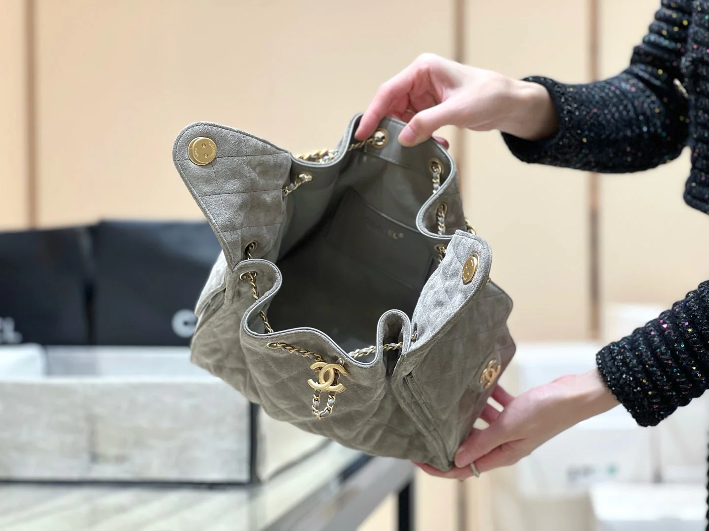 Популярная сумка-хобо Chanel 25c, которую можно носить под мышкой — серо-коричневая.