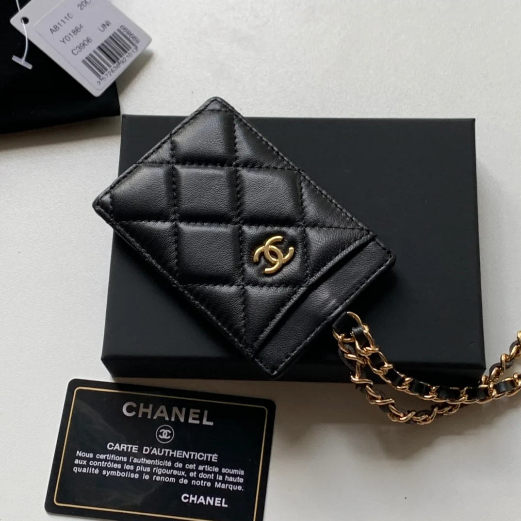 Держатель для удостоверений личности Chanel — из черной овечьей кожи с золотой пряжкой.