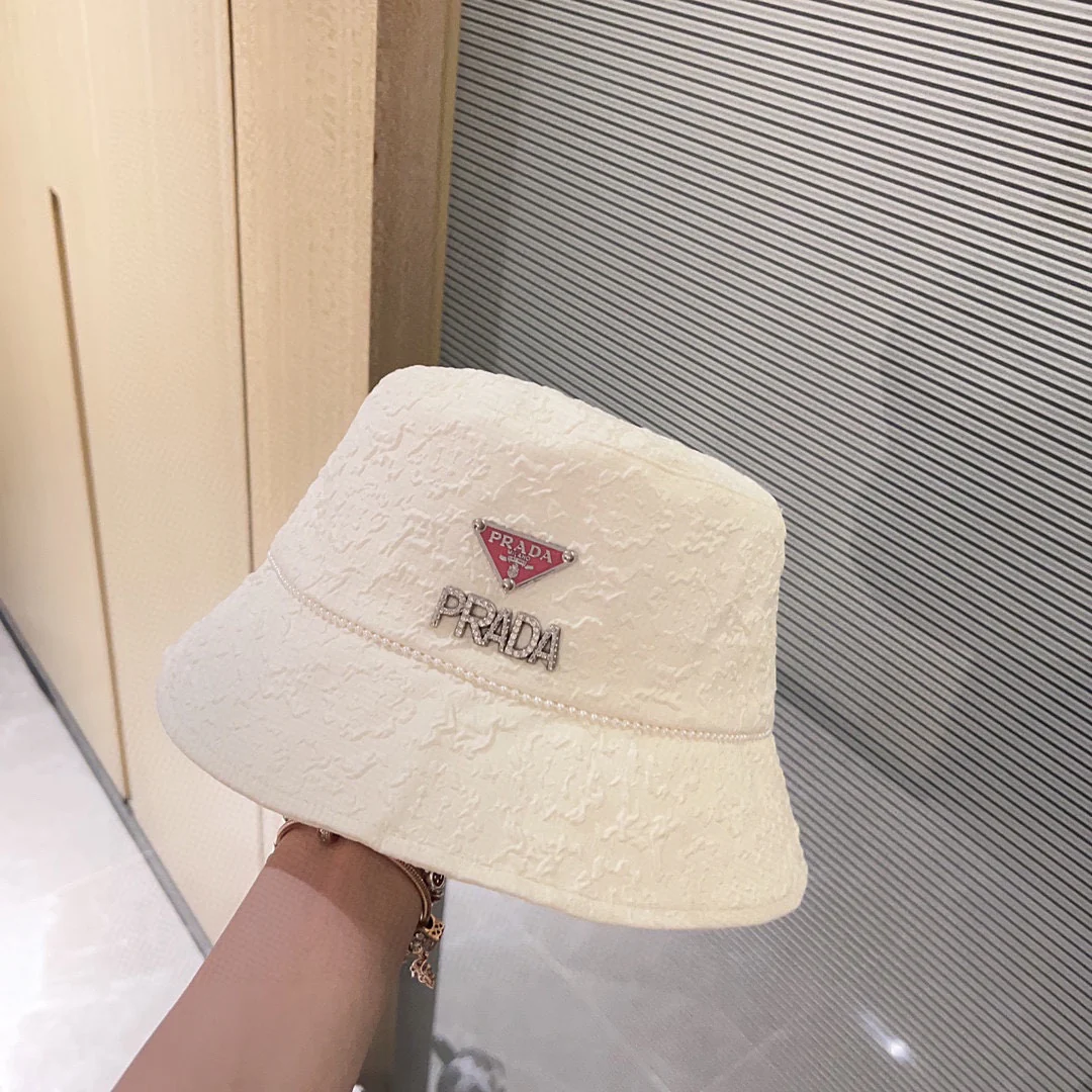 Новая рыбацкая шляпа Prada 2023 в стиле Chanel с жемчужной цепочкой — белая.
