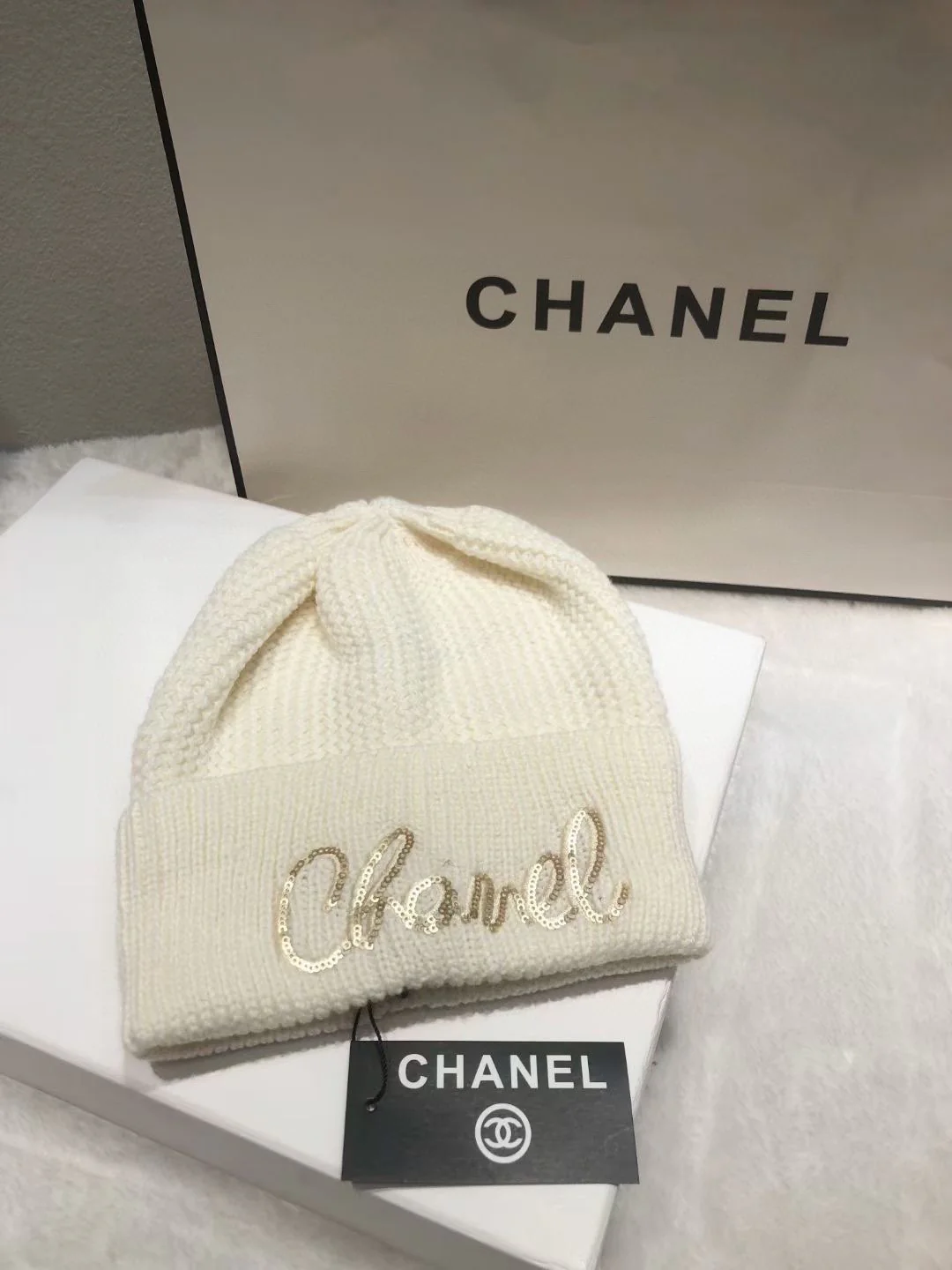 Вязаная шапка Chanel с пайетками и курсивной надписью