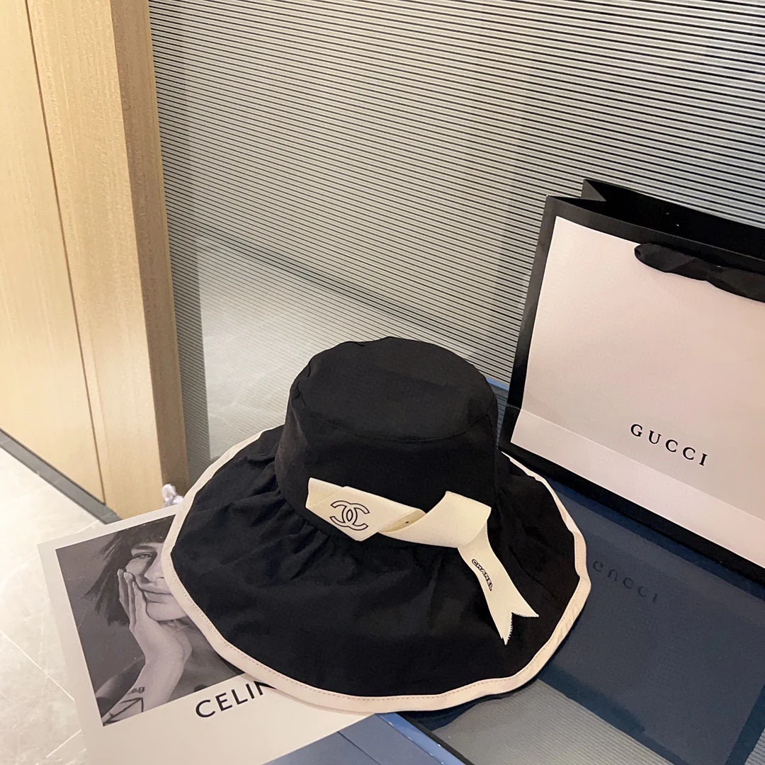 Новая коллекция Chanel 2023 года: широкополая рыбацкая шляпа с бантом в курортном стиле - черная.