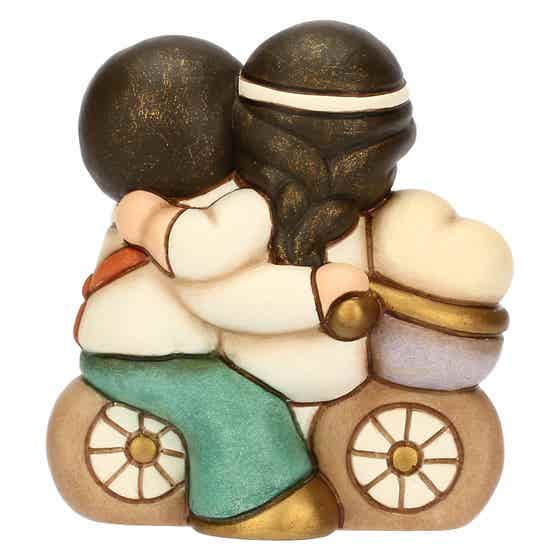 Small ceramic newlyweds on bicycles