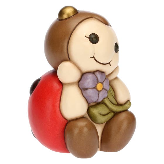 Large ladybird with lilac flower