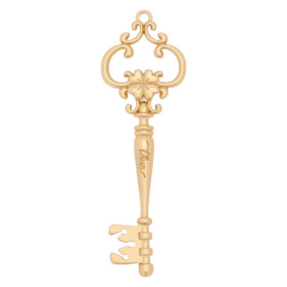 Metal key with four-leaf clover