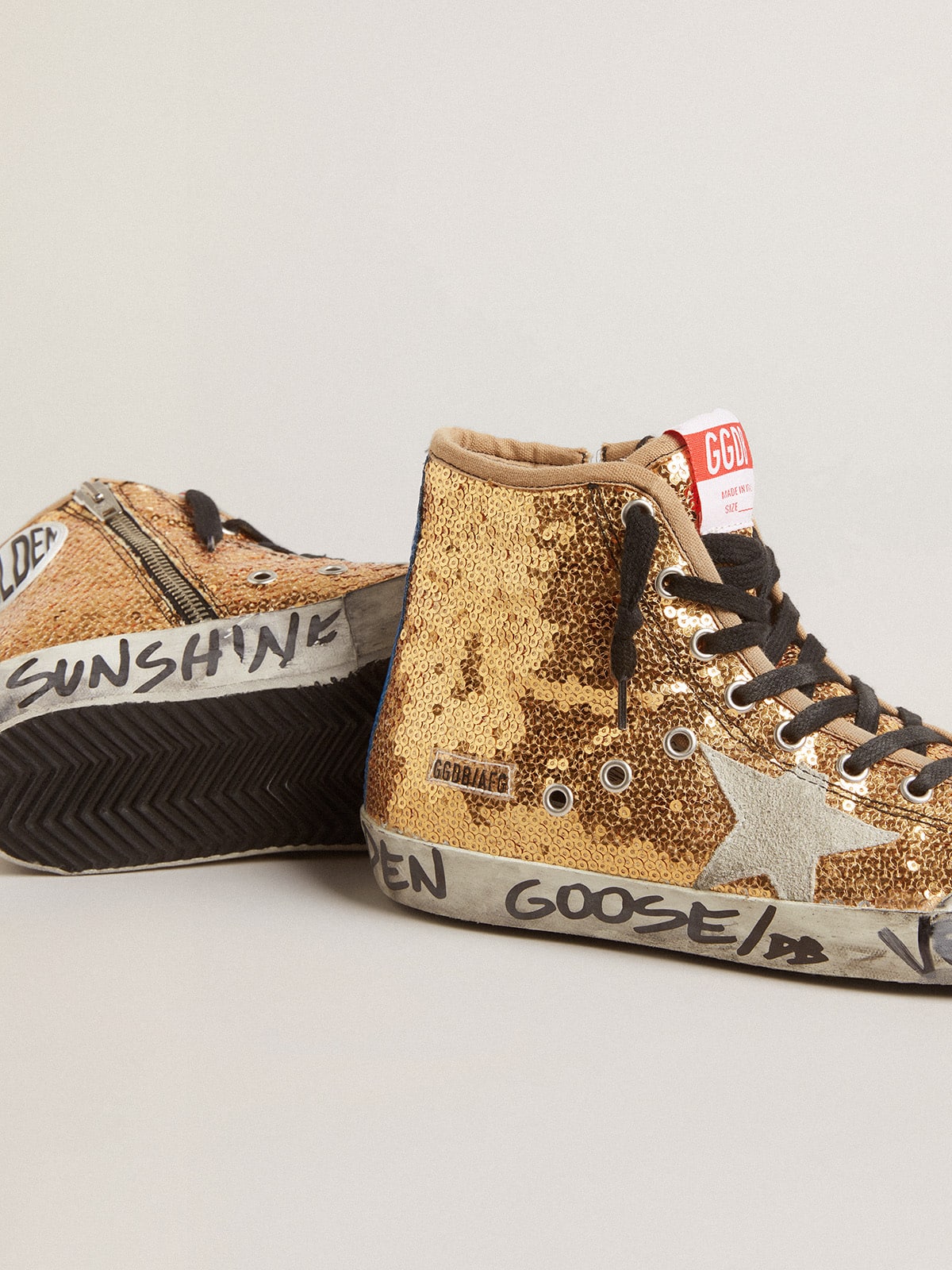 Francy Penstar in gold paiettes with suede star and bright blue heel tab