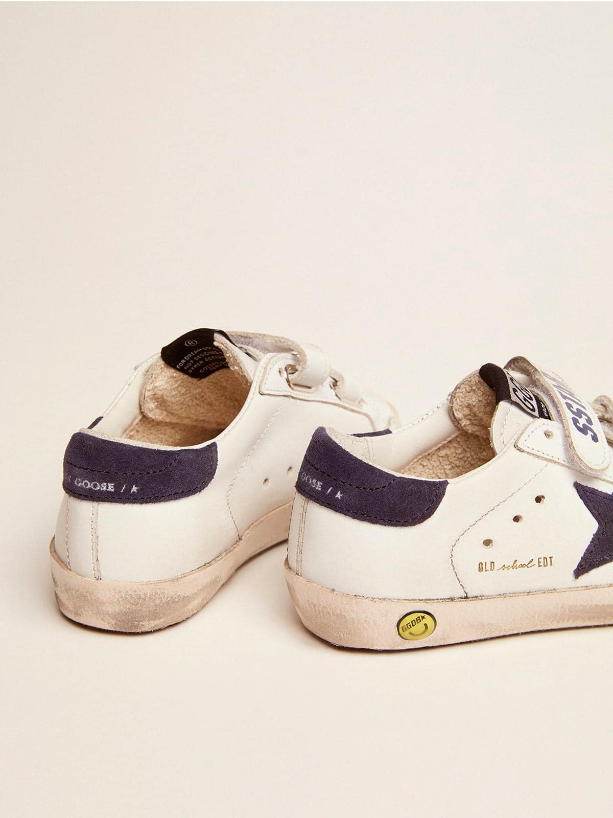 Old School Junior in white leather with blue suede star and heel tab