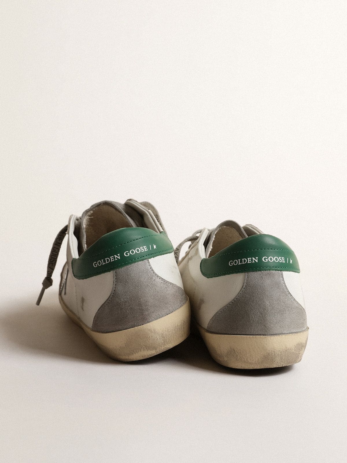 Men's Super-Star in white leather with silver star and green heel tab
