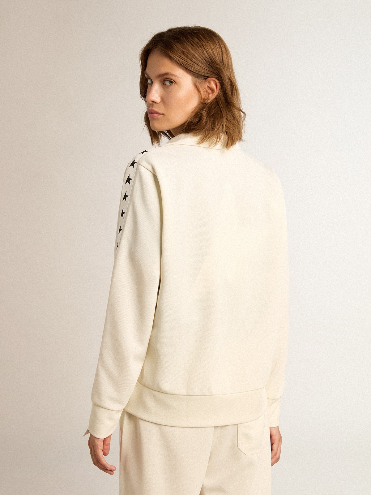 Women's white zipped sweatshirt with white strip and black stars