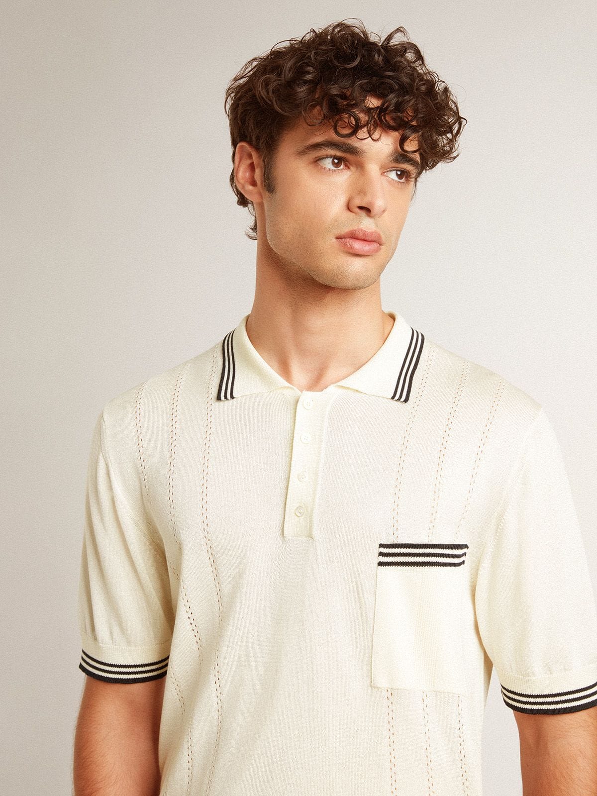 Men's worn-white knitted polo shirt with blue ribbing