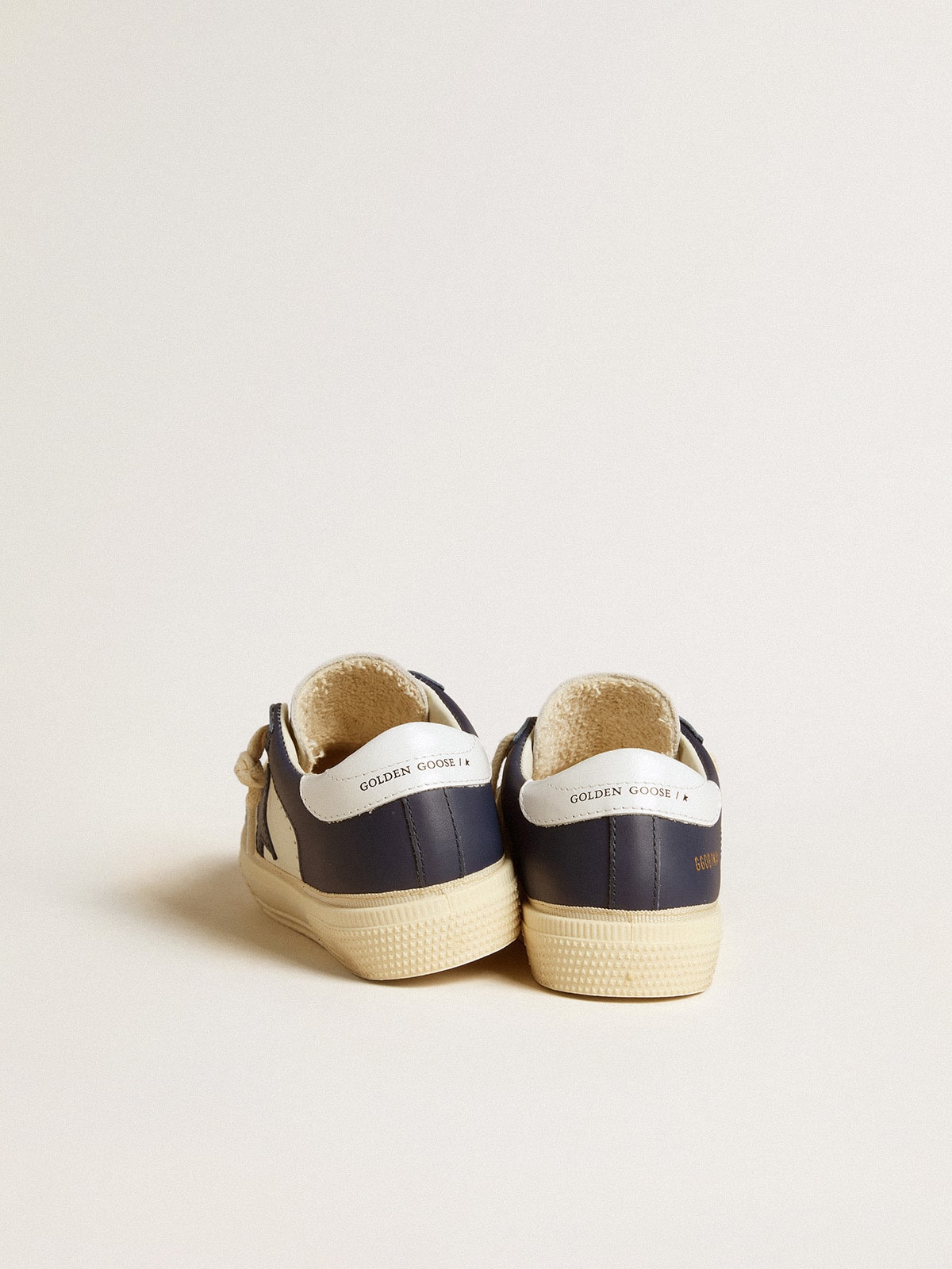 May Young in white and blue leather with leather star and heel tab