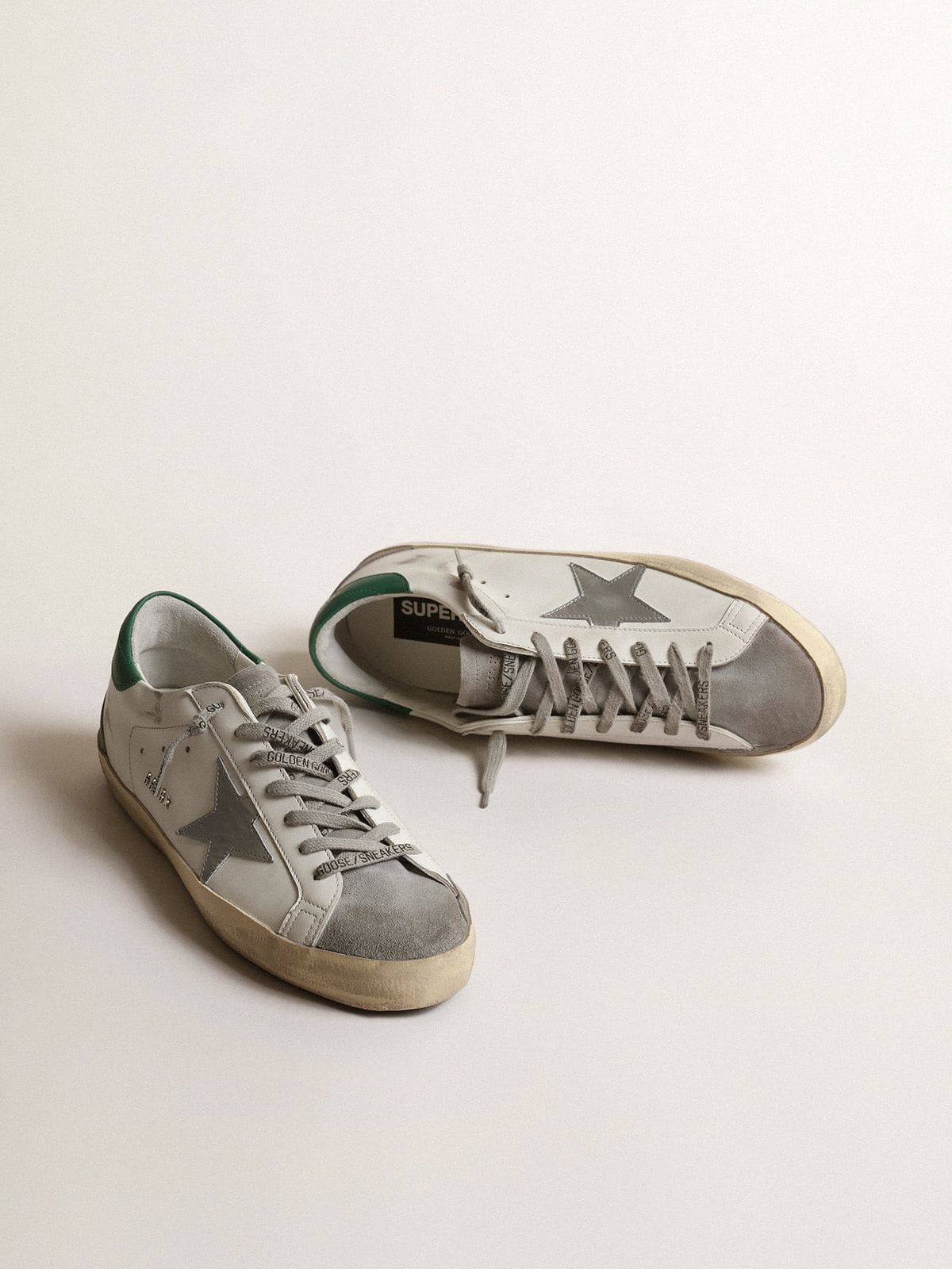 Men's Super-Star in white leather with silver star and green heel tab