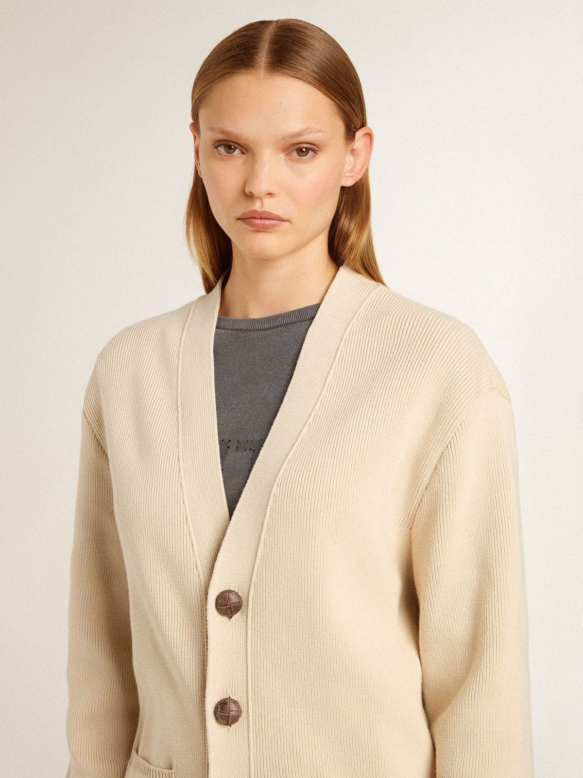Women's beige cardigan with 'Golden' lettering on the back