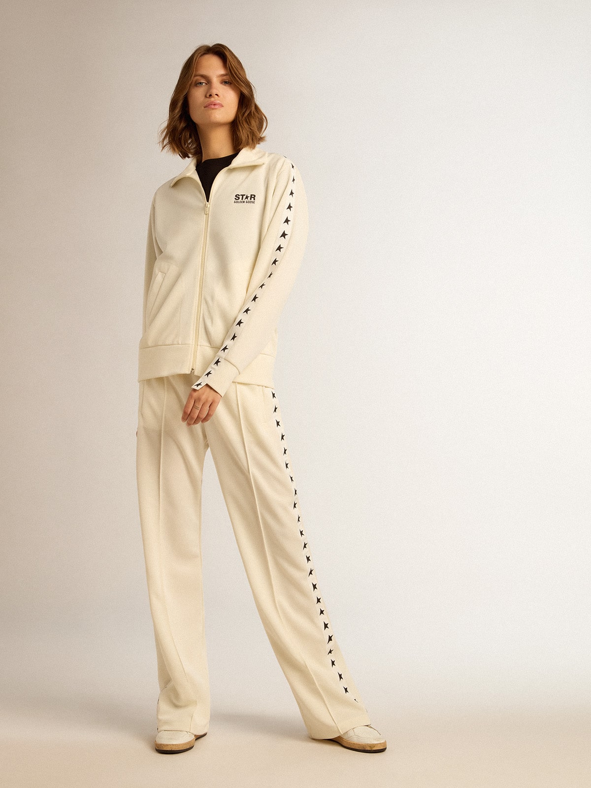 Women's white joggers with stars on the sides