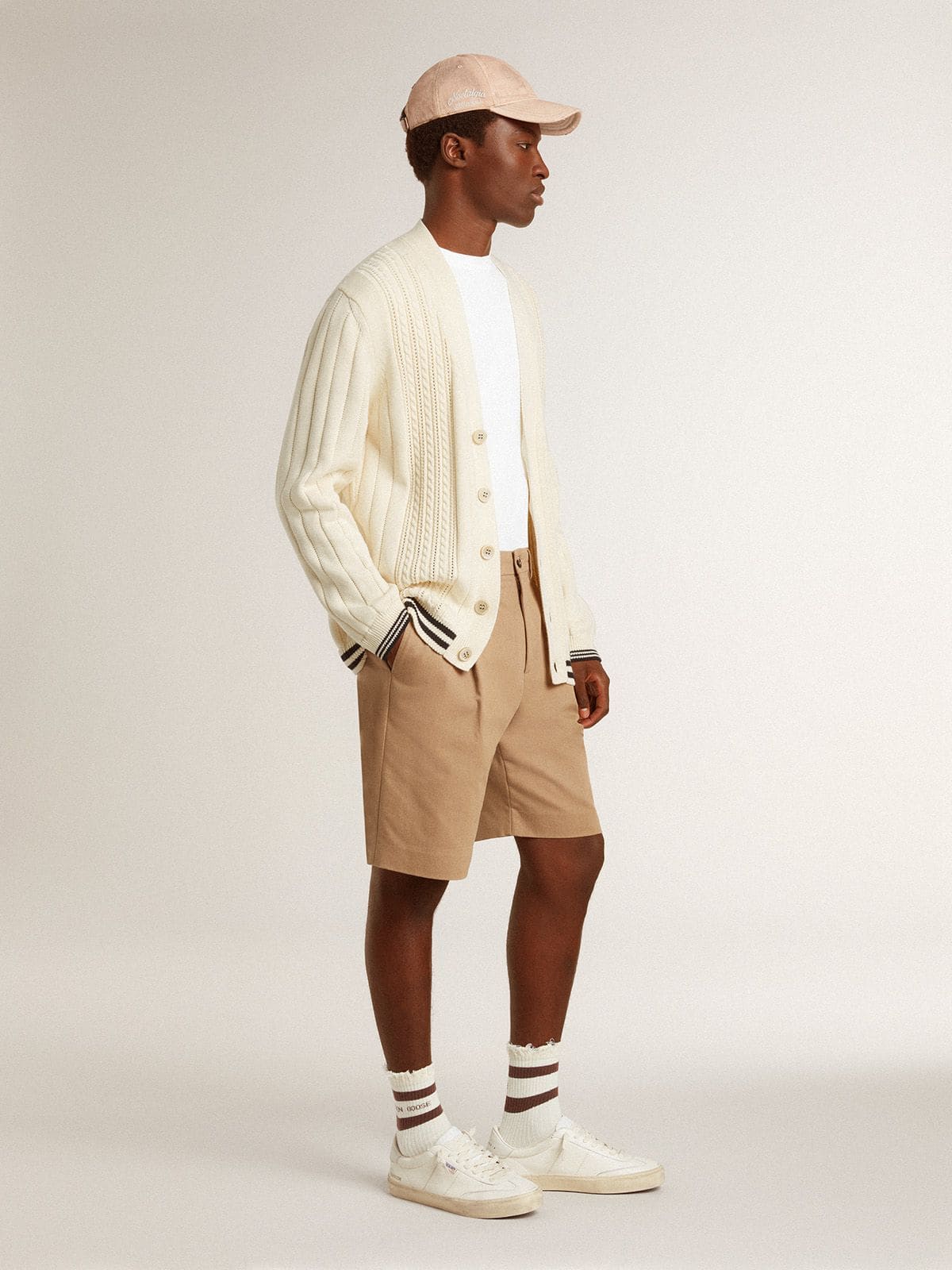 Men's white cotton cardigan with a cable pattern and blue ribbing