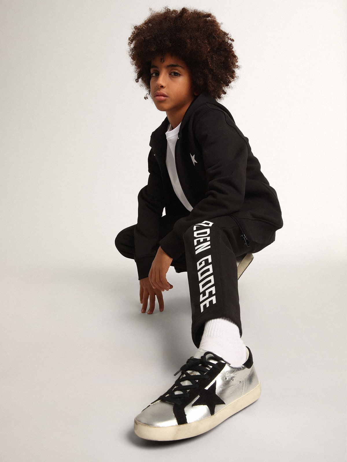 Black hooded sweatshirt with contrasting white star and logo