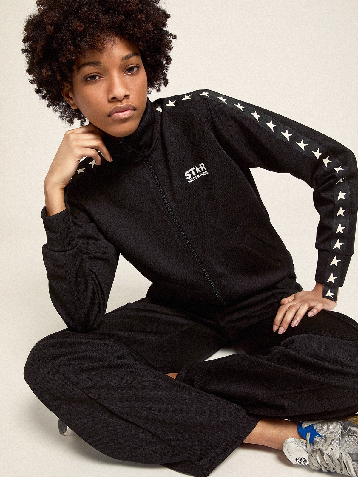 Women's black joggers with white stars on the sides