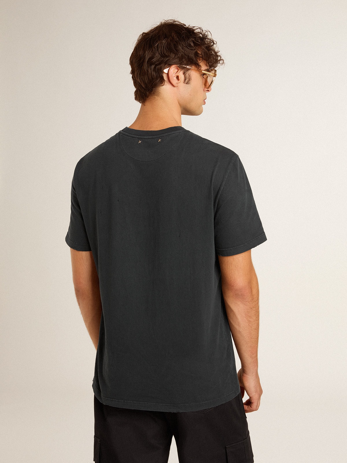 Men's worn-black cotton T-shirt with print on the front