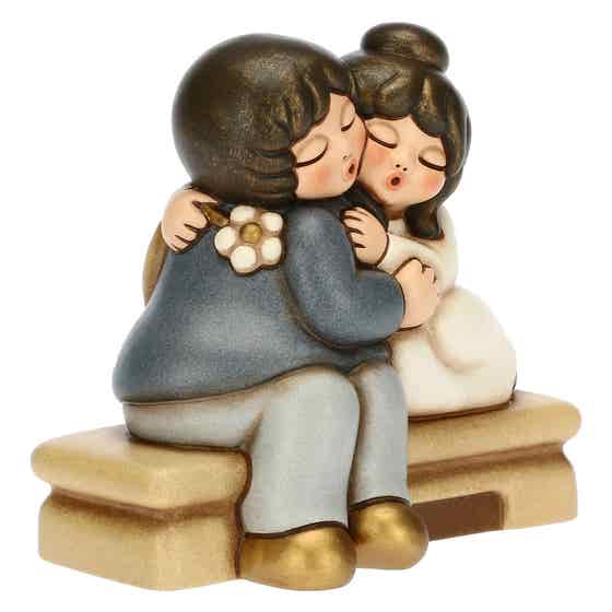 Large seated embracing newlyweds